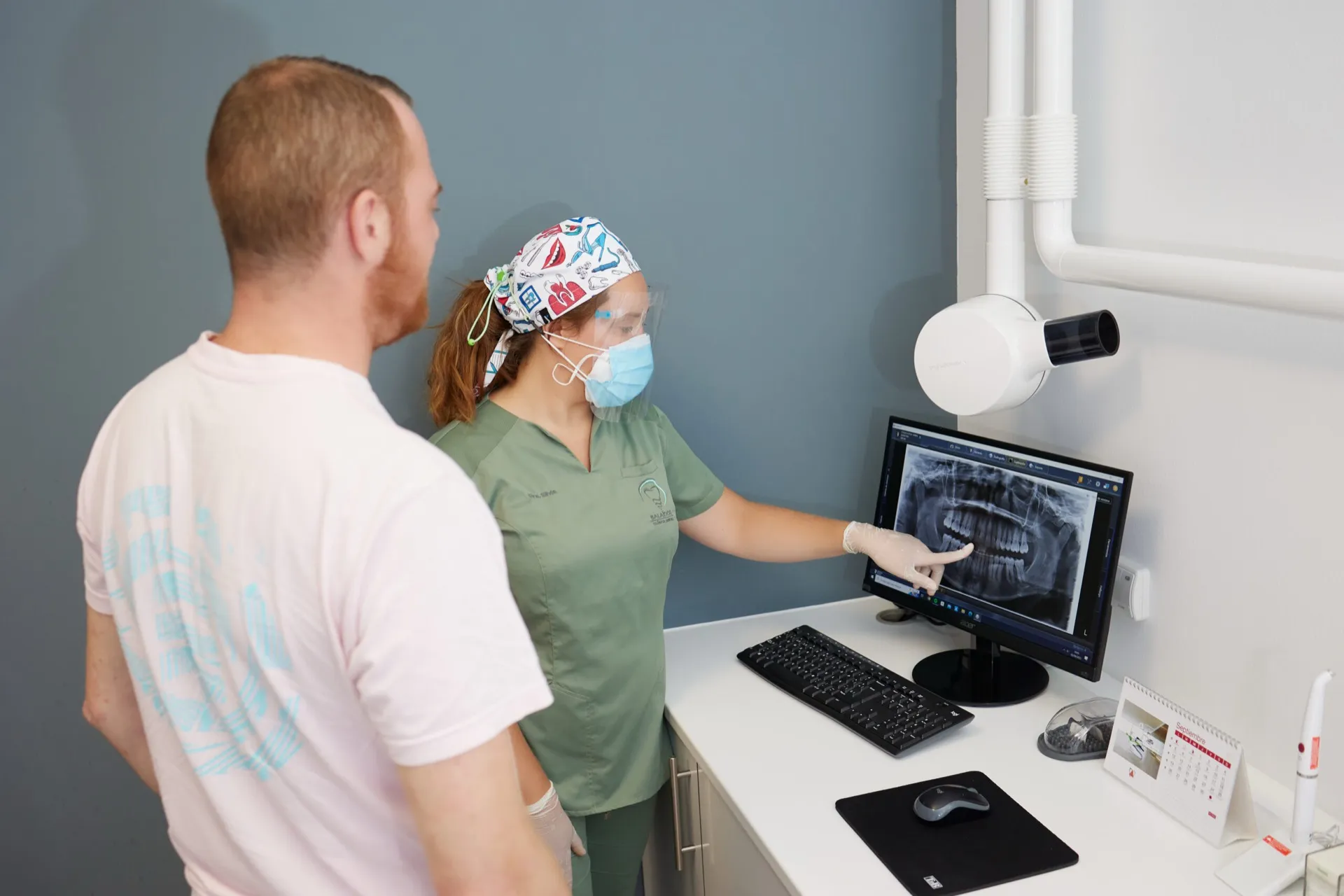Doctora de Clínica Dental Balaídos revisando una radiografía panorámica con un paciente